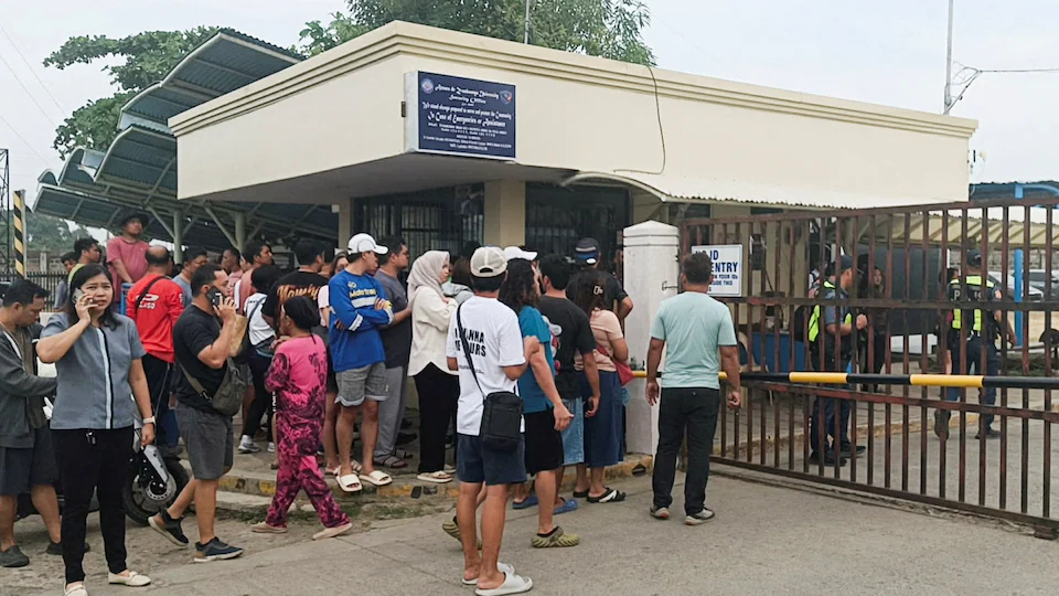 Parents and others gather outside a school in the shooting incident.