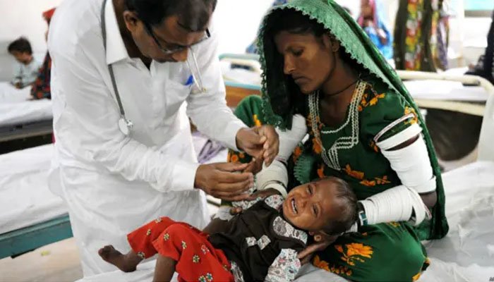 A child being vaccinated in a village in Sindh.