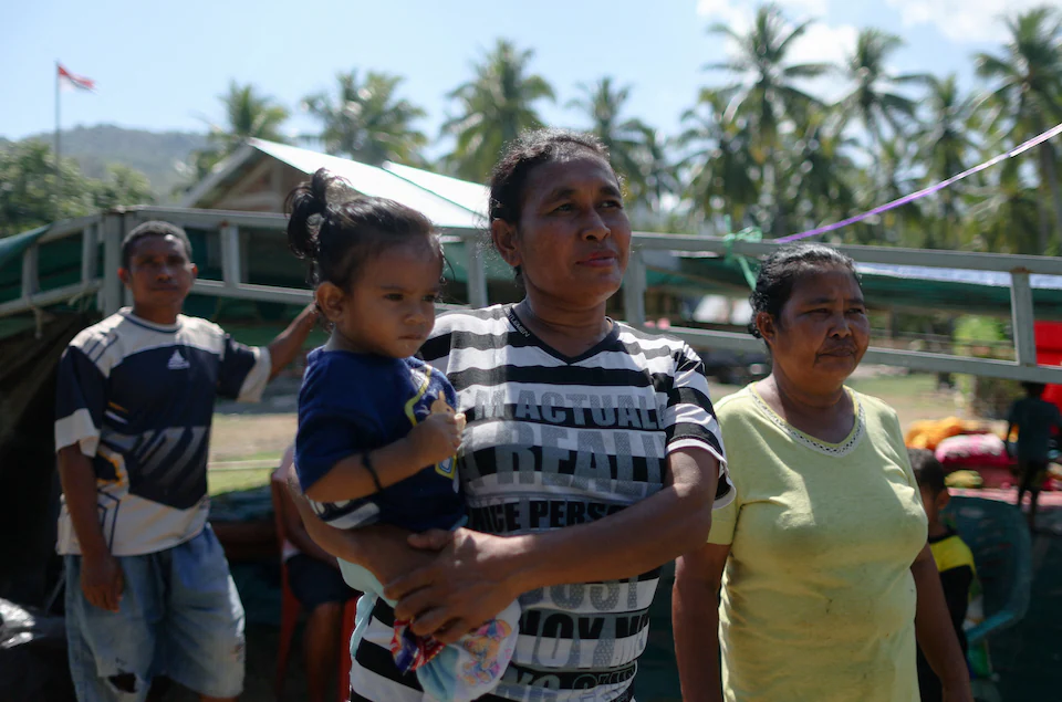 Survivors look for relatives as sear h ongoing for missing people after Indonesia earthquake.