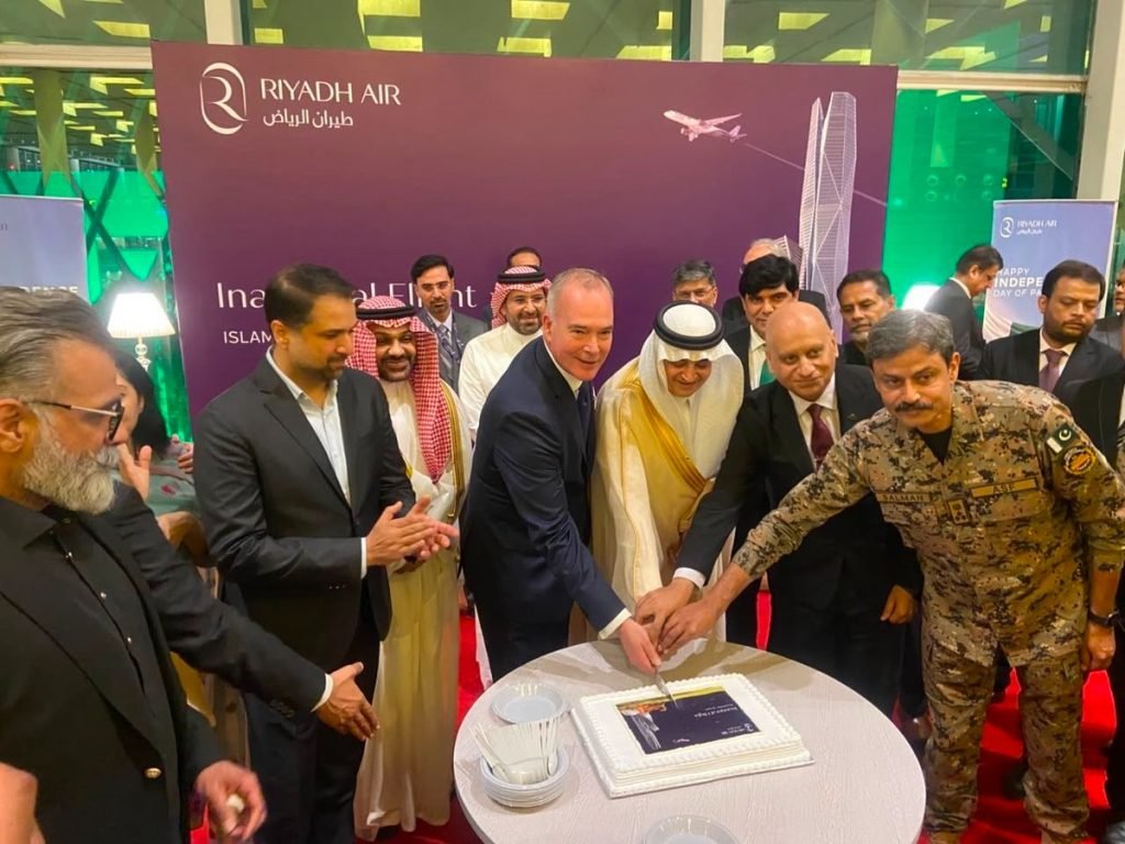 Officials cut a cake on inauguration of Riyadh Air service to Pakistan.
