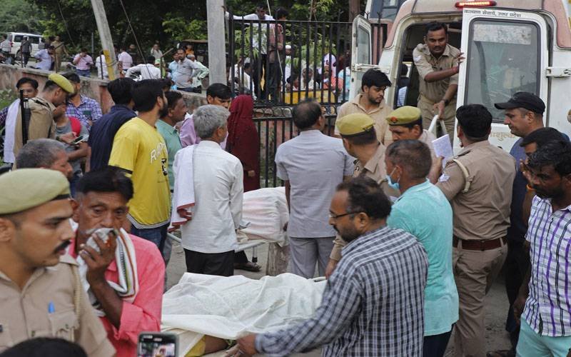 People gather outside the building in India after an stampede.