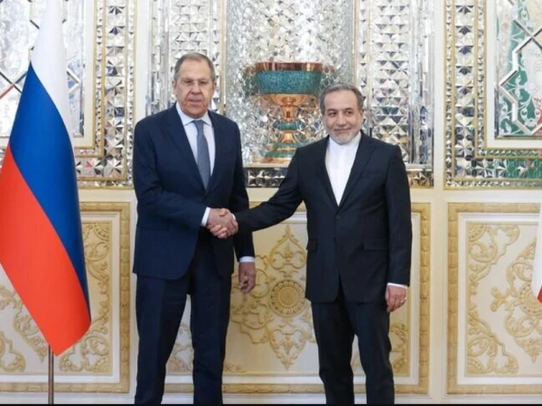 Russian and Iranian foreign ministers shake hand before their meeting in Tehran.
